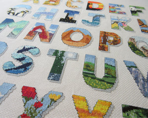 Cross stitch picture showing part of a Scenic Alphabet pattern, with large alphabet letters filled with scenes of the natural world