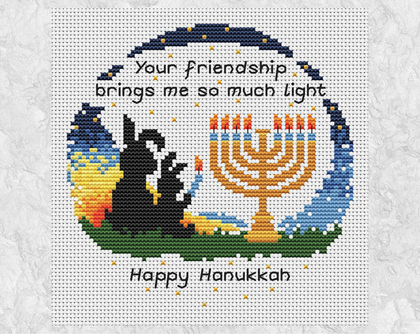 Hanukkah Friendship cross stitch pattern. Bunnies lighting a menorah with the words 'Your friendship brings me so much light - Happy Hanukkah'. Shown without frame.