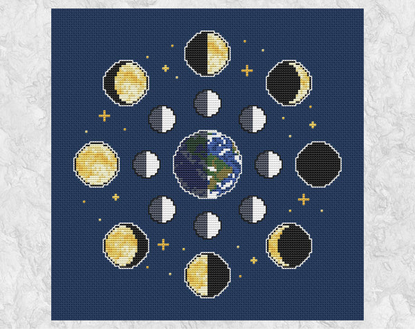 Moon Phases cross stitch pattern on dark fabric. Shown without frame.