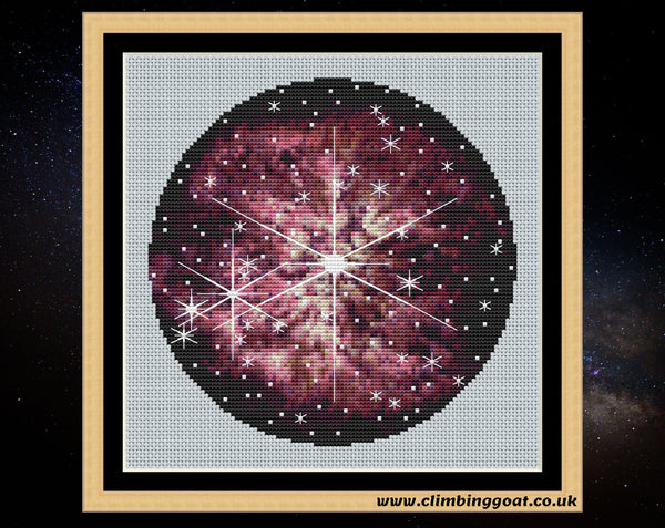 Wolf-Rayet 123 cross stitch pattern. A large star in the centre of the image is puffing off layers of pink gas and dust. Many other stars are in the picture. Some of the stars have large 8 line diffraction spikes, seen only in JWST images. Shown in frame.