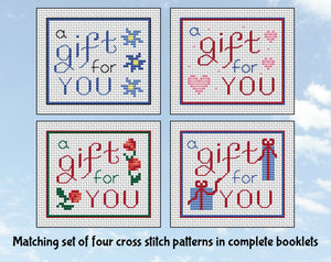 Matching set of four cross stitch patterns all with the text 'a gift for you'. Set 1.