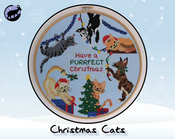 Christmas Cats cross stitch pattern. Six fun cartoon cats putting up Christmas decorations. Shown in hoop.