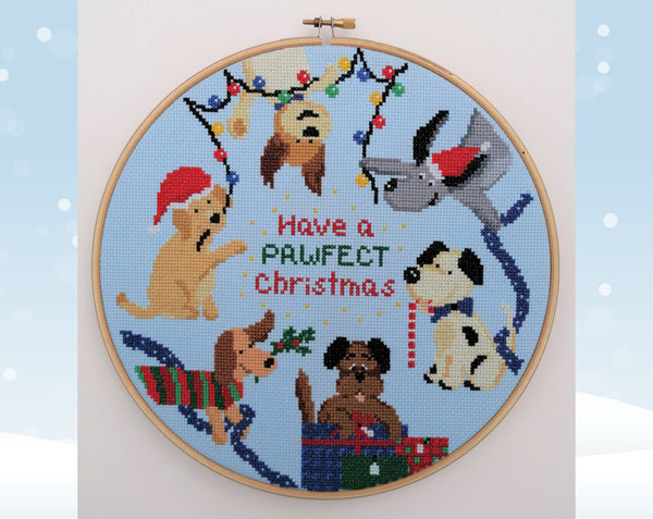 Christmas Dogs cross stitch pattern. Six cartoon dogs in a hoop with the words 'Have a pawfect Christmas'.