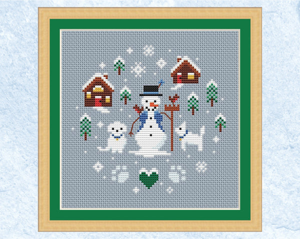 Snowman and Snowdogs cross stitch pattern. Shown in frame.