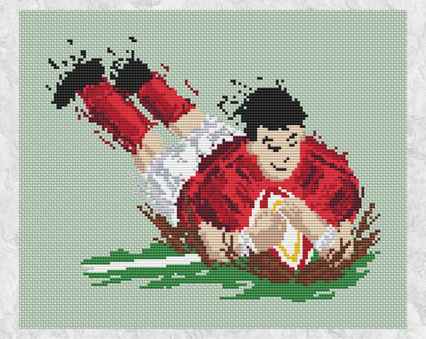 Splattered Paint Rugby Player cross stitch pattern. Design of a rugby player throwing himself over the touchline with the ball, scoring a try. Shown without frame.