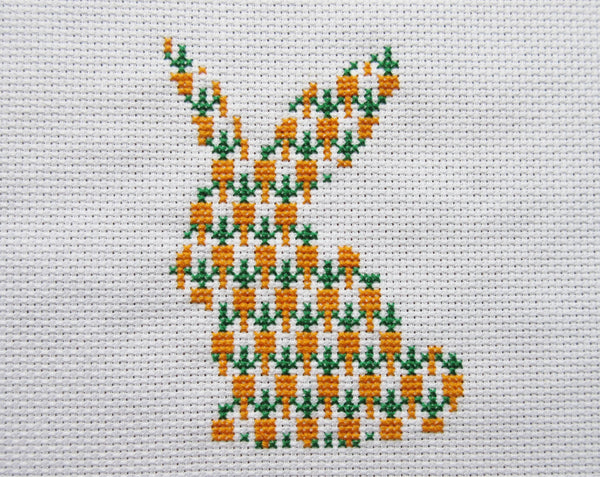 Carrot Bunny cross stitch pattern - silhouette of a rabbit filled with carrots. Straight view of stitched piece.