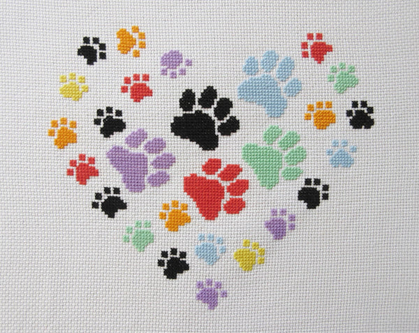 Cross stitch pattern of a heart made up of paw prints