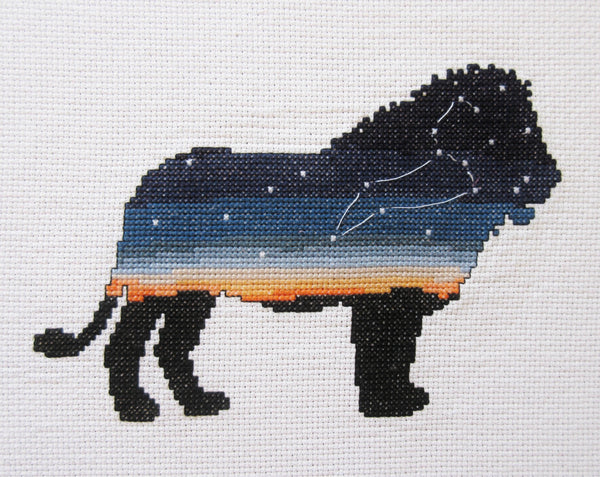 Leo Zodiac Lion cross stitch pattern - silhouette of lion filled with sky, sunset and the constellation of Leo. Stitched piece.