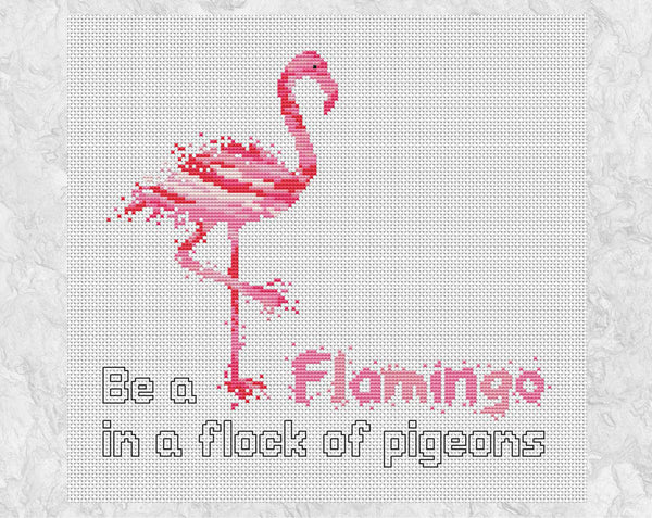 Cross stitch pattern PDF of a watercolour effect flamingo, with the words 'Be a Flamingo in a flock of pigeons'. Shown without frame.