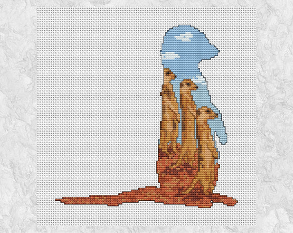 Cross stitch pattern PDF of the silhouette of a meerkat, filled with three more meerkats watching astutely for any trouble! Shown without frame.