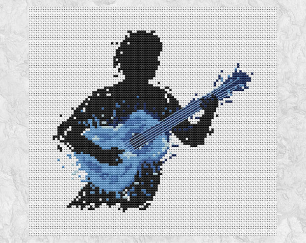 Male guitarist music cross stitch pattern - splattered paint style. Shown without frame.