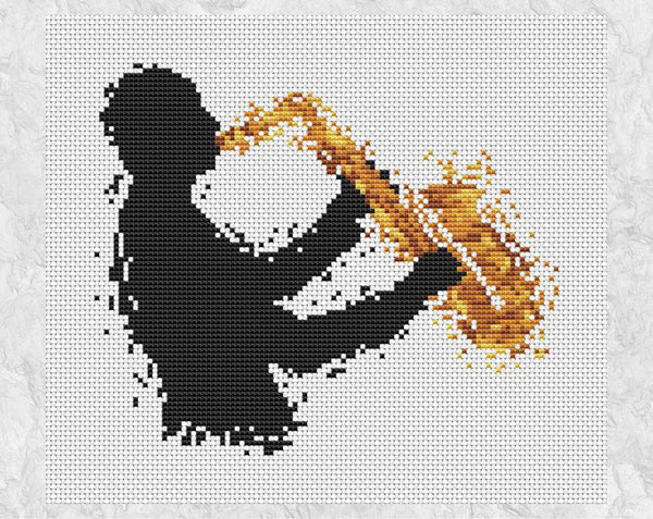 Cross stitch pattern of splattered paint male saxophonist player. Shown without frame.