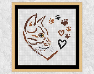 Cross stitch pattern PDF of a cat, hearts and paw prints forming a larger heart. With frame.