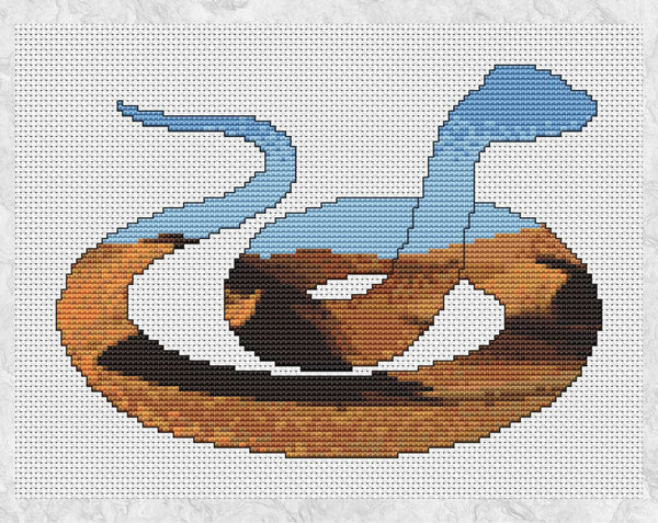 Cross stitch pattern PDF of the silhouette of a snake, filled with a desert of shifting dunes. Shown without frame.