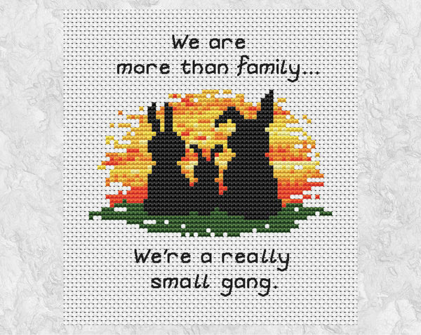 Cross stitch pattern of three bunny silhouettes against a sunset, with the words "We are more than family... We're a really small gang.". Shown without frame.