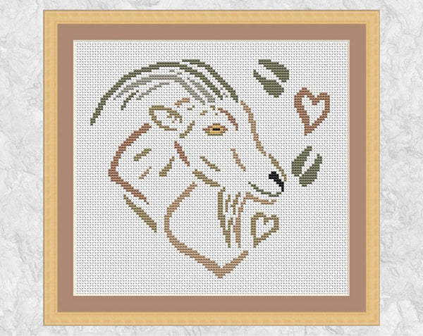 Cross stitch pattern of a goat, hearts and hoof prints, all forming a heart. Shown with frame.