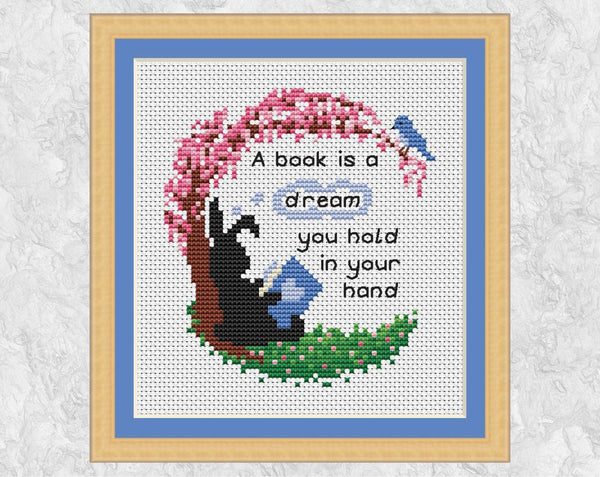 Book quote cross stitch pattern - 'A book is a dream you hold in your hand' - Together Bunnies Collection - shown with frame