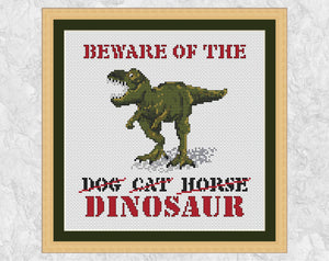 Cross stitch pattern of a dinosaur with the words BEWARE OF THE DINOSAUR