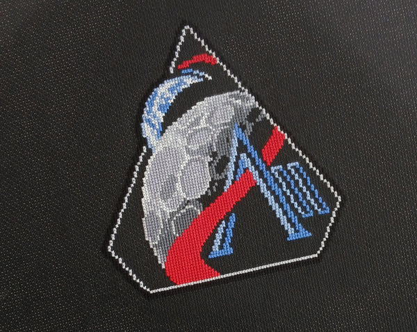 Artemis II Mission Patch cross stitch pattern. Angled image of stitching.
