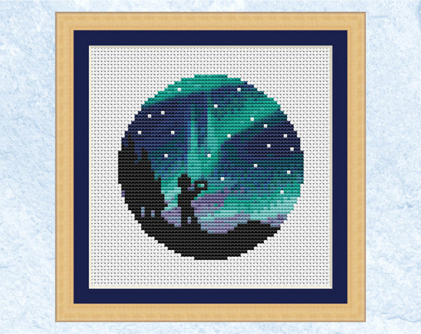 Aurora cross stitch pattern. Version with photographer silhouette. Shown in frame.