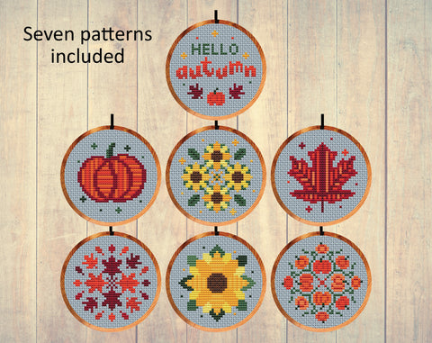 Autumn Minis cross stitch patterns by Climbing Goat Designs. Set of seven patterns in 3 inch hoops. One says 'Hello Autumn'; there are two pumpkin patterns, two sunflower patterns and two leaf patterns.