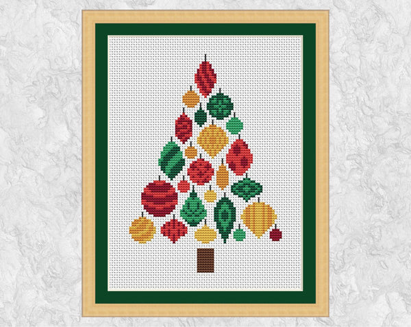 Christmas Tree of Baubles cross stitch pattern. Christmas tree shape made up of patterned baubles in shades of red, green and gold. Shown in frame.
