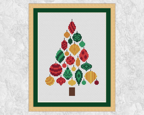Christmas Tree of Baubles cross stitch pattern. Christmas tree shape made up of patterned baubles in shades of red, green and gold. Shown in frame.