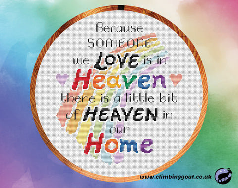 Bereavement cross stitch pattern with the words "Because someone we love is in heaven, there is a little bit of heaven in our home" arranged over a pastel rainbow. Shown in hoop.