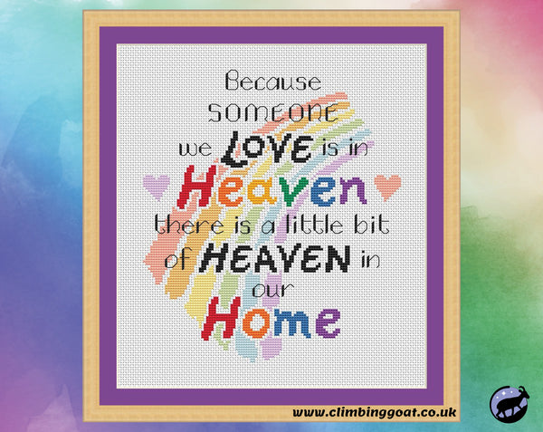 Bereavement cross stitch pattern with the words "Because someone we love is in heaven, there is a little bit of heaven in our home" arranged over a pastel rainbow. Shown in frame.