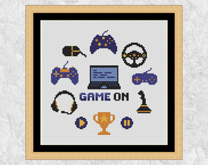 Game On computer games cross stitch pattern. Shown in frame.