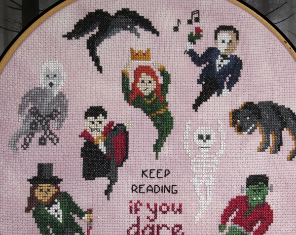 Halloween by the Book cross stitch pattern. Close up of upper half of stitched piece.