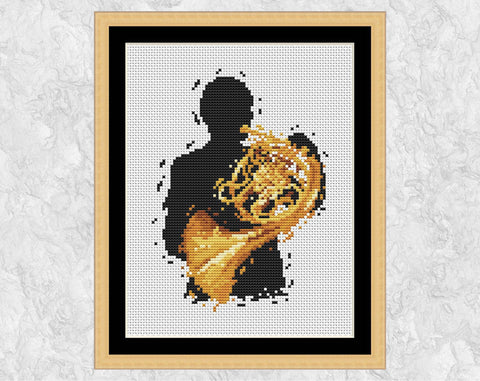 Male French Hornist cross stitch pattern. Shown in frame.