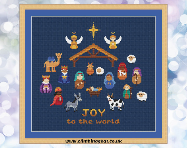 Nativity cross stitch pattern. Cute characters portraying the whole traditional Nativity scene. Shown on navy blue fabric.