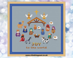Nativity cross stitch pattern. Cute characters portraying the whole traditional Nativity scene. Shown on blue fabric.