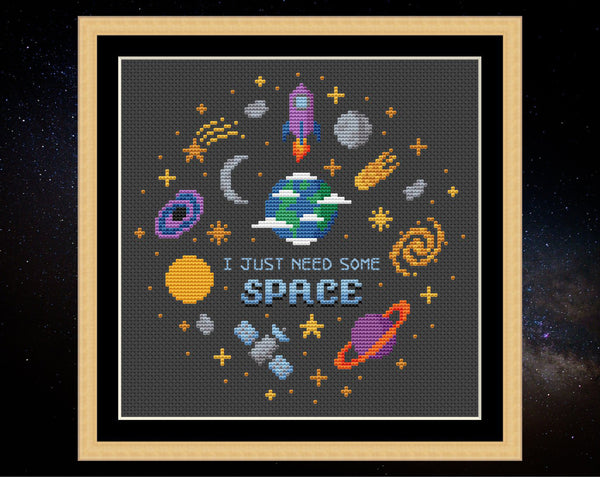 I Just Need Some Space cross sittch pattern. Fun astronomy motifs. Design on black fabric in frame.