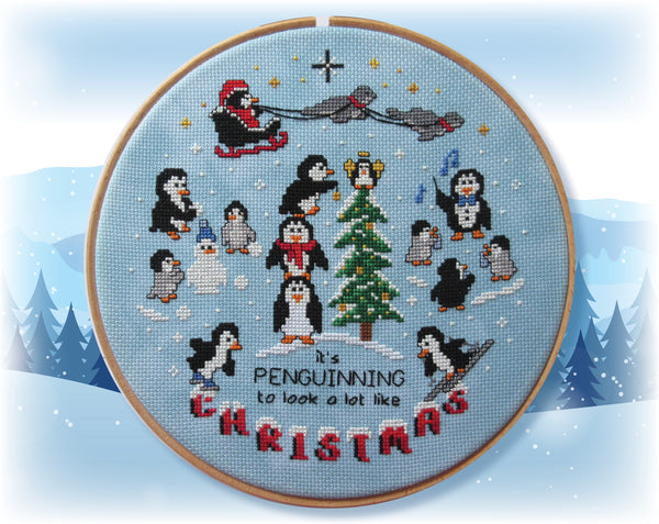 Penguin Christmas cross stitch pattern. A scene of cute cartoon penguins doing different Christmassy things, with the words "it's penguinning to look a lot like Christmas".