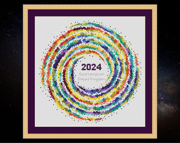 Rainbow Temperature Galaxy cross stitch pattern - example image for Southampton for 2024, shown on white fabric in square frame. Maximum and minimum temperatures pattern version.