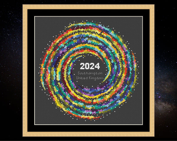 Rainbow Temperature Galaxy cross stitch pattern - example image for Southampton for 2024, shown on black fabric in square frame. Maximum and minimum temperatures pattern version.