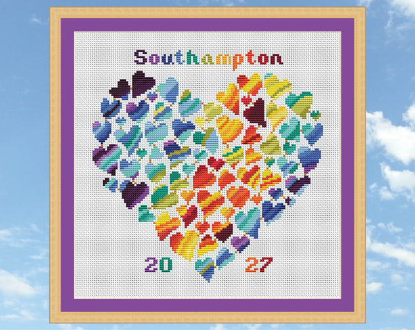 Rainbow Temperature Heart cross stitch pattern by Climbing Goat Designs. Shown in frame on white fabric.