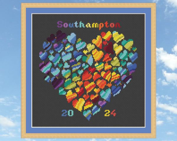 Rainbow Temperature Heart cross stitch pattern. Shown in frame on black fabric.