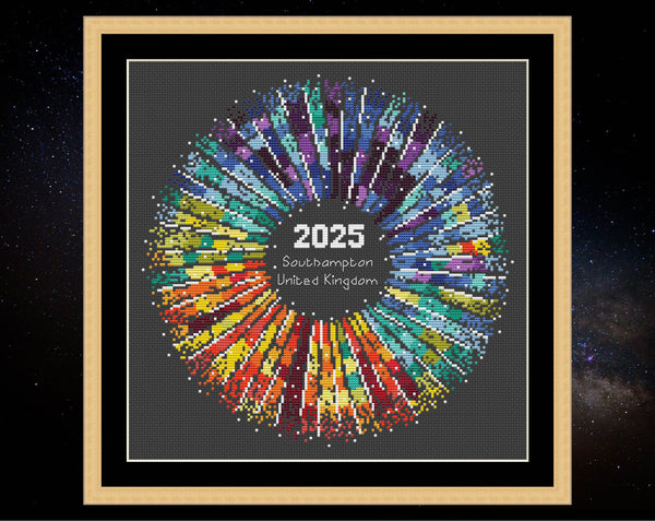 Rainbow Temperature Supernova cross stitch pattern. Shown in frame on black fabric.