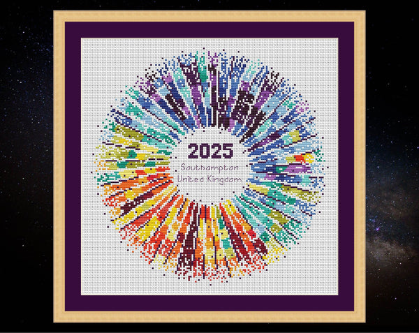 Rainbow Temperature Supernova cross stitch pattern. Shown in frame on white fabric.