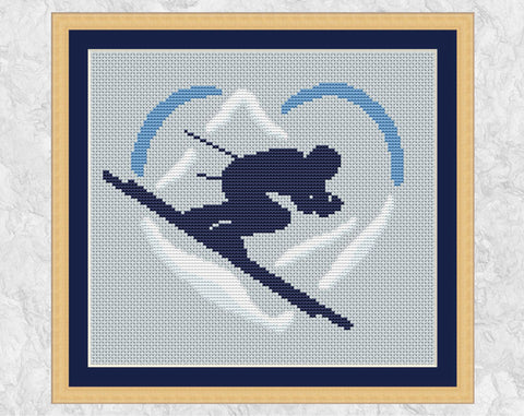Skiing Heart cross stitch pattern. Shown in frame.