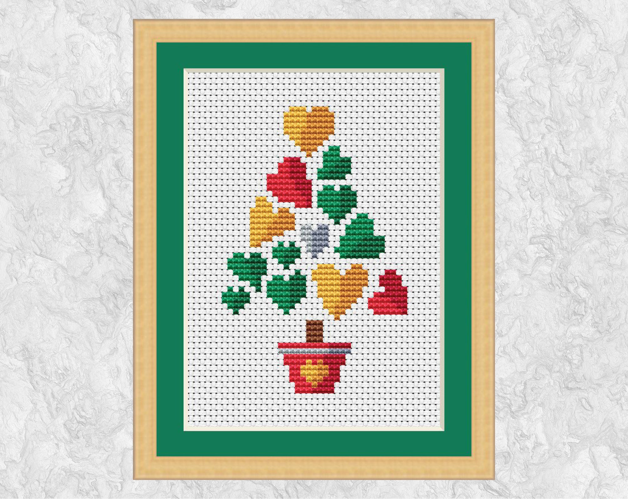Smaller Hearts Christmas Tree cross stitch pattern. Shown in frame.