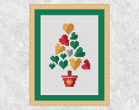 Smaller Hearts Christmas Tree cross stitch pattern. Shown in frame.