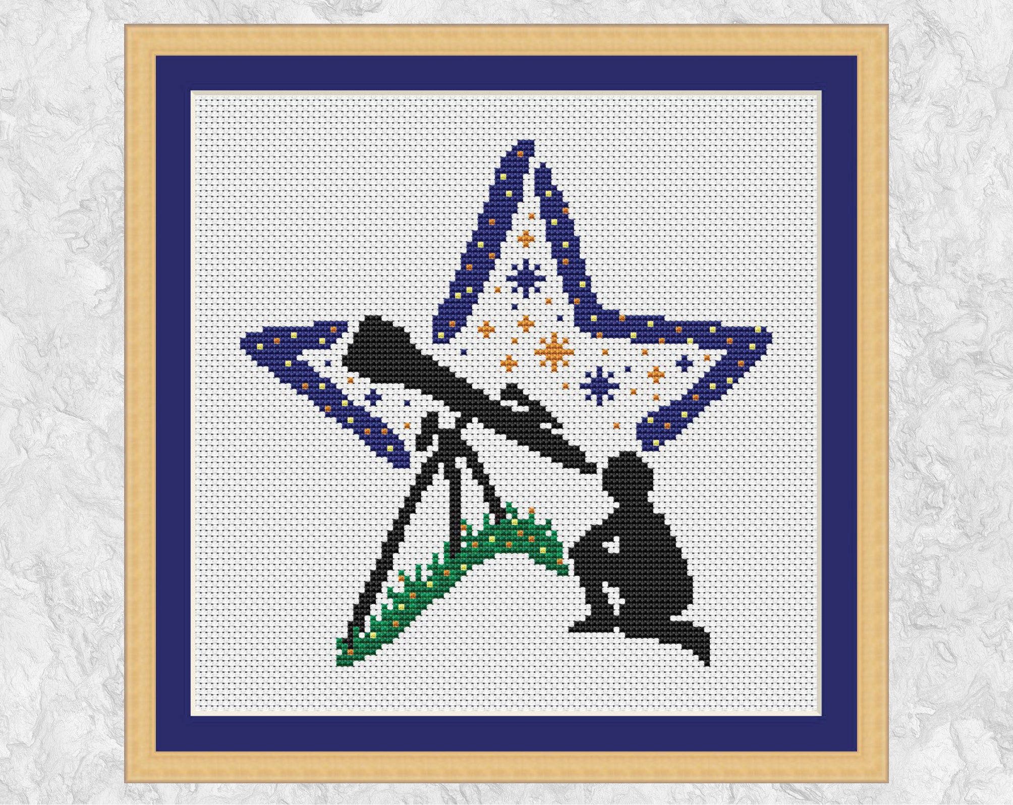 Stargazing Star cross stitch pattern. Silhouette of a person gazing through a telescope with a star shaped background. Shown in frame.