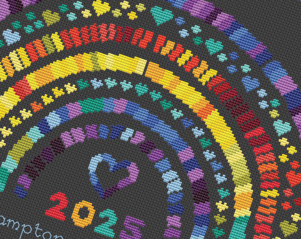 Temperature Rainbow cross stitch pattern. Close up of pattern on black fabric.