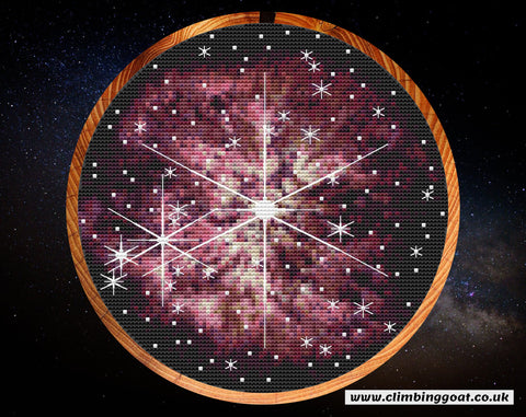Wolf-Rayet 123 cross stitch pattern. A large star in the centre of the image is puffing off layers of pink gas and dust. Many other stars are in the picture. Some of the stars have large 8 line diffraction spikes, seen only in JWST images. Shown in hoop.