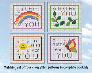 Matching set of four cross stitch patterns all with the text 'a gift for you'. Set 2.