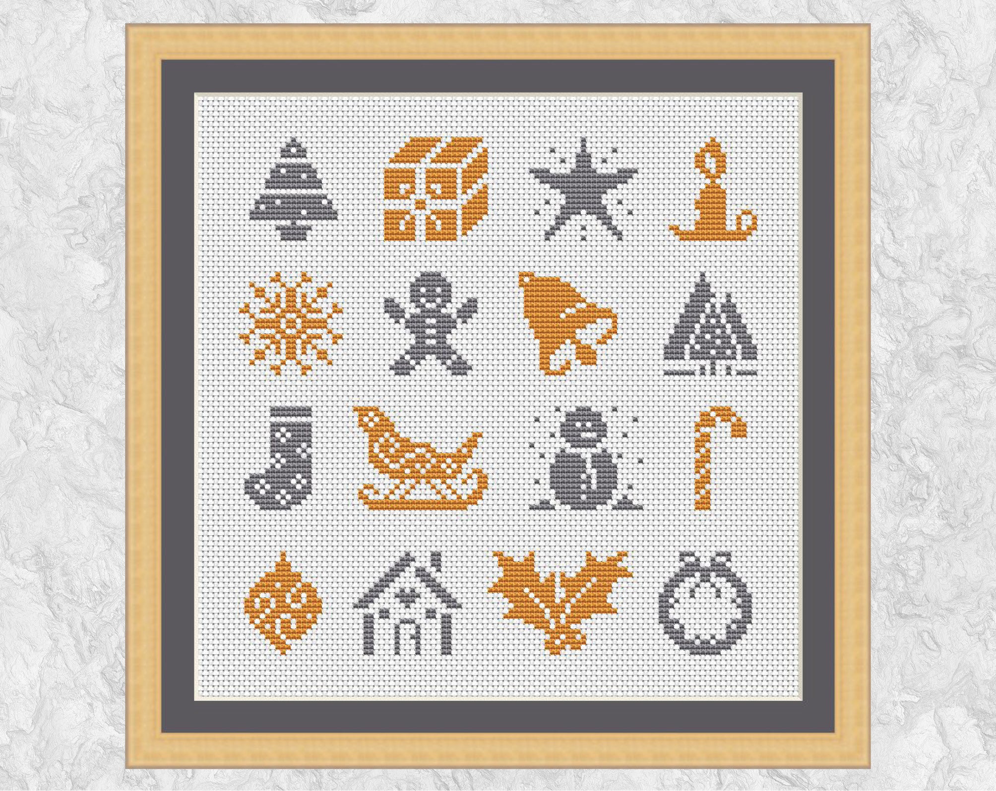 Cross stitch pattern of mini Christmas motifs suitable for Christmas cards or gift tags. The motifs shown are: Single Christmas tree; gift; star; candle; snowflake; gingebread man; bell; several Christmas trees; stocking; sleigh; snowman; candy cane; bauble; gingerbread house; holly; wreath. Shown with frame.